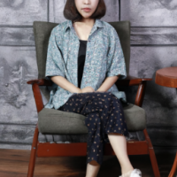 A girl sitting on the chair, her outfit is very professional